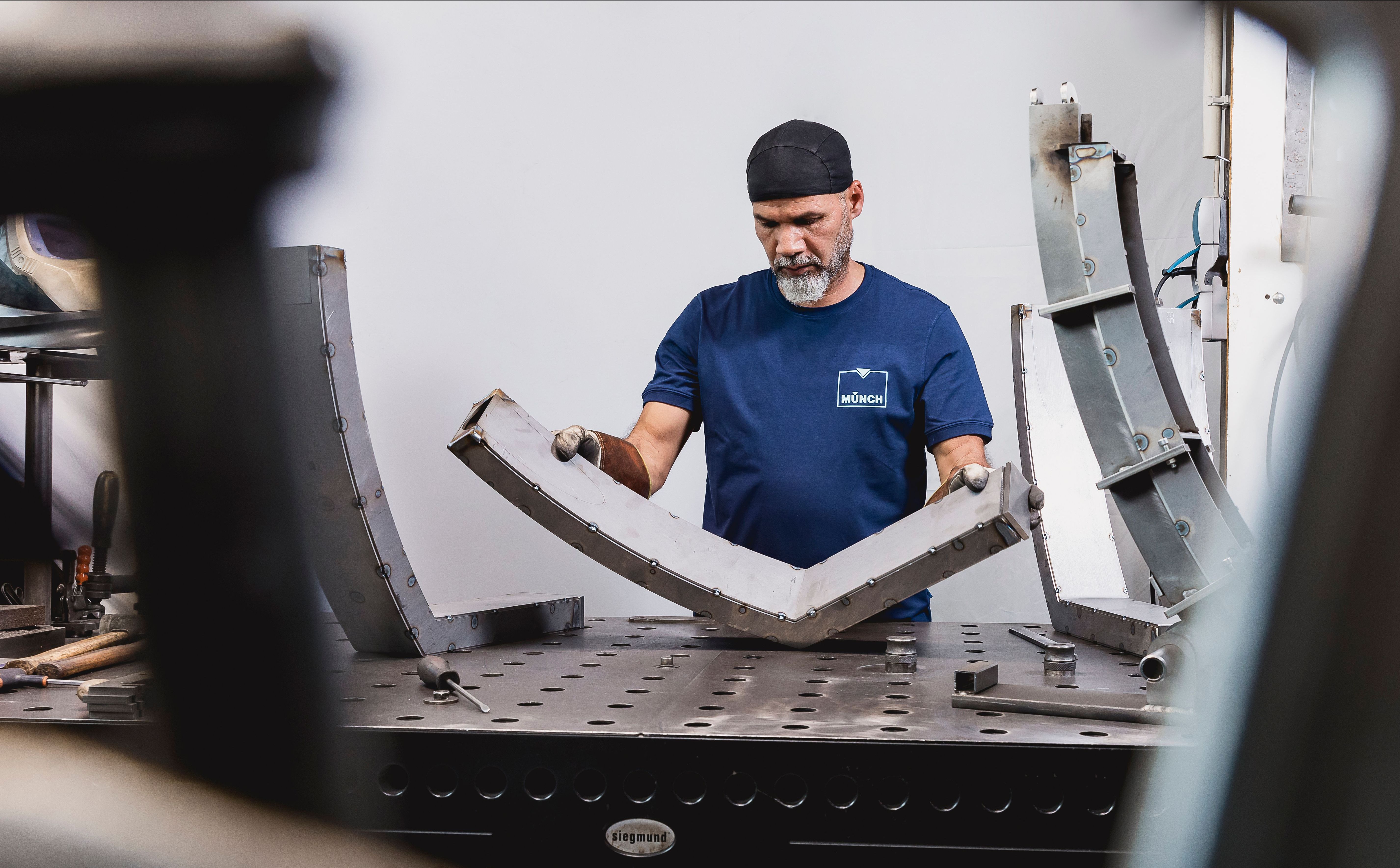 Mitarbeiter mit Schweißbauteil